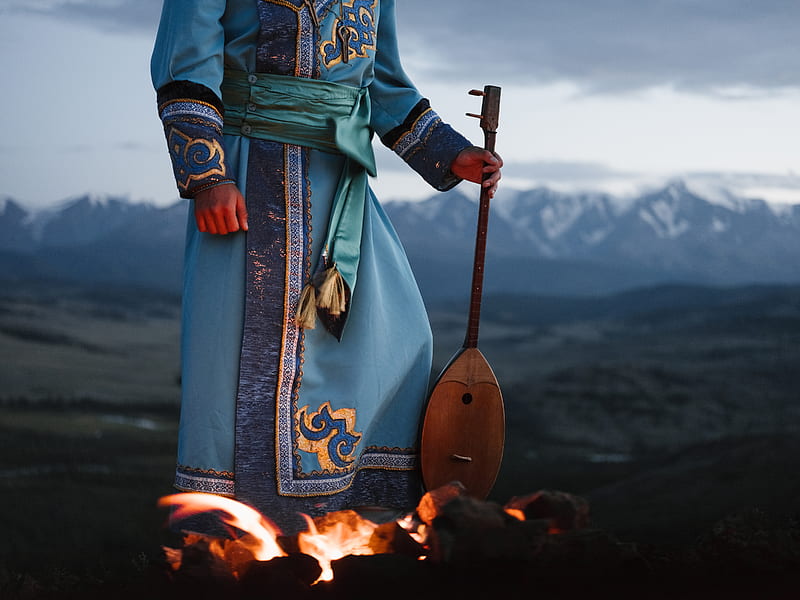 Crop person standing near bonfire with Mongolian folk instrument in valley, HD wallpaper