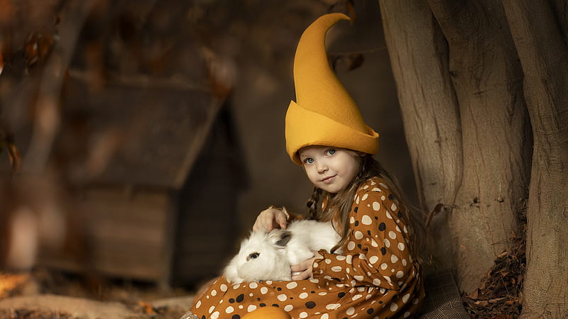 Cute Little Girl With White Rabbit On Lap Is Wearing Brown Dress And Yellow Hat Sitting Near Tree Trunk Cute, HD wallpaper