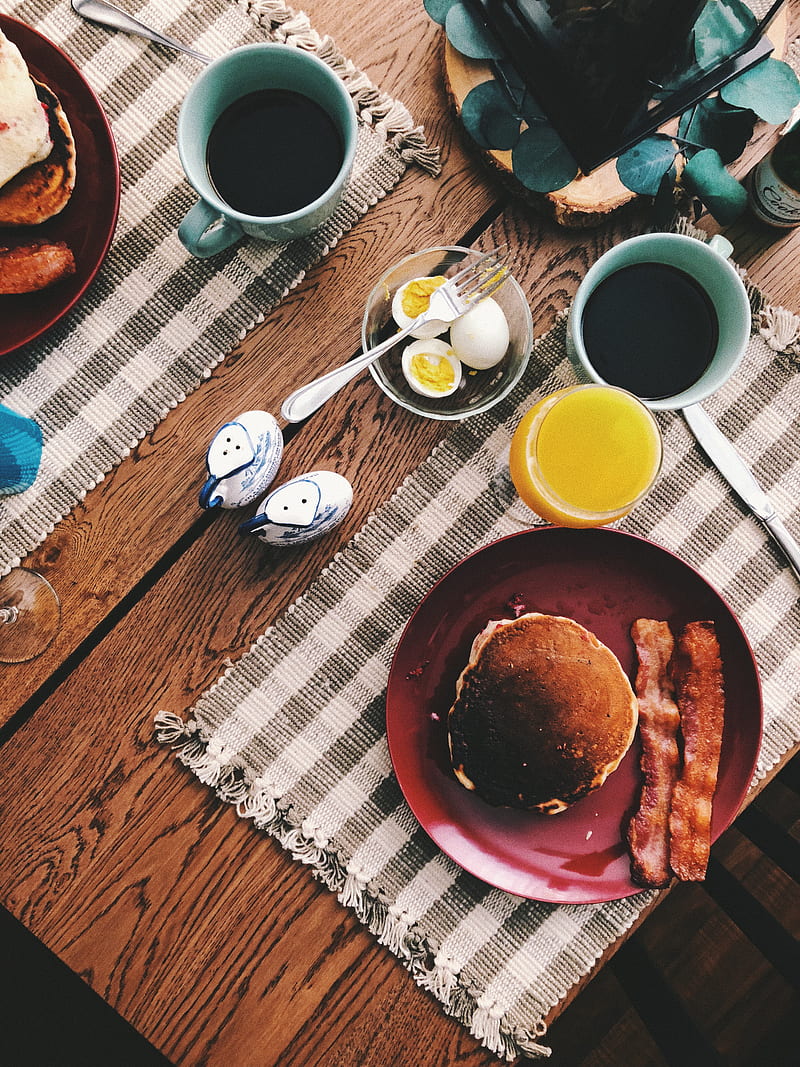 baked bread on round red ceramic plate near glass of orange juice, cup of coffee, and boiled eggs, HD phone wallpaper