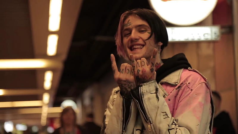 smiley lil peep is showing hand signs in blur light background wearing sandal coat music, HD wallpaper