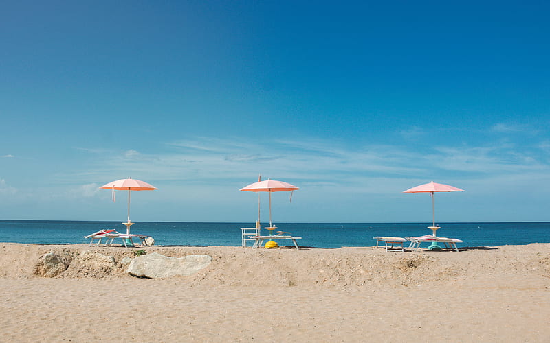 three empty beach loungers with umbrellas overlooking the beach under blue sky, HD wallpaper