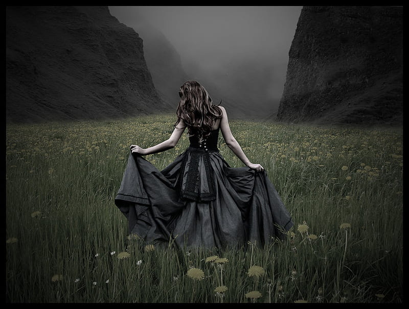 Beautiful mysterious mystical girl with long hair in black dress
