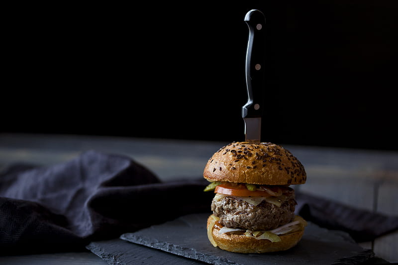 burger skewered with knife near black textile, HD wallpaper