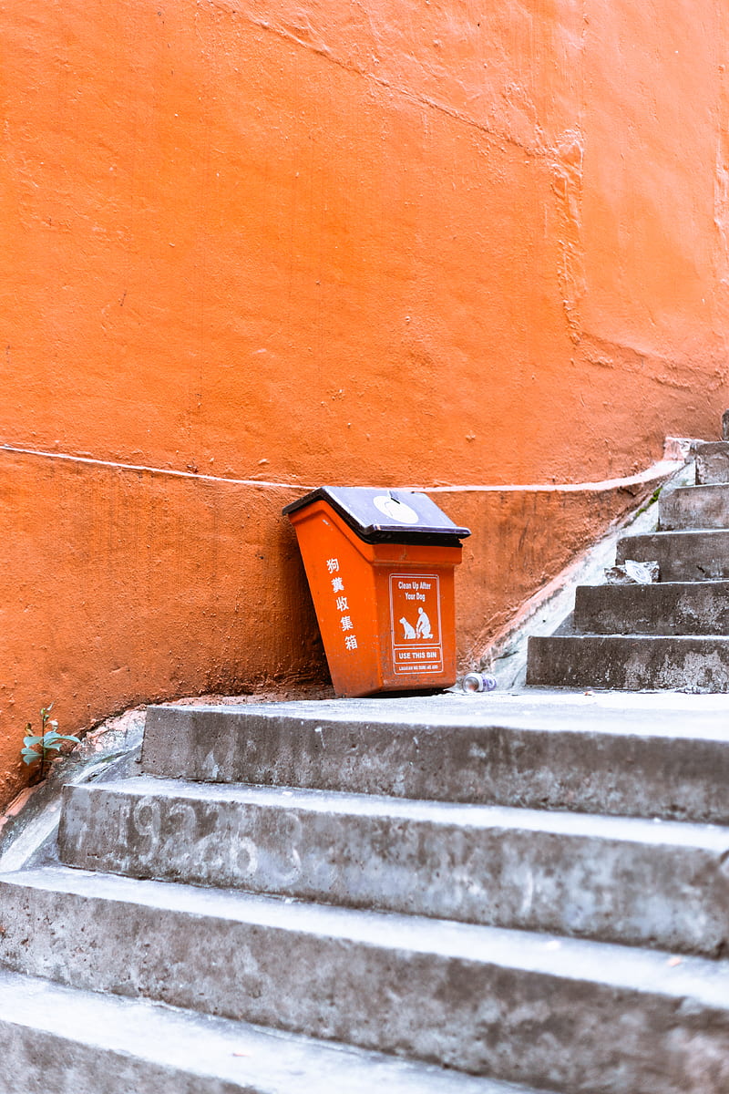orange and black plastic trash bin beside orange painted wall, HD phone wallpaper