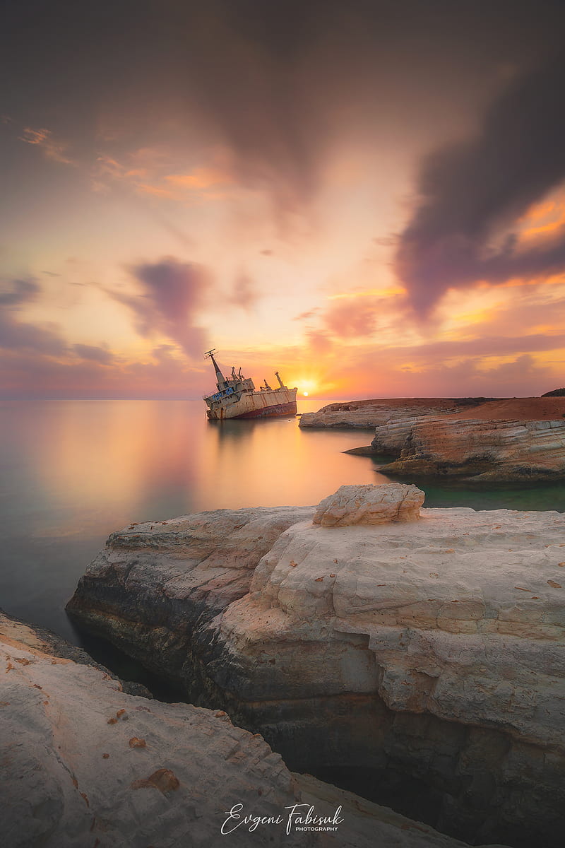 nature, landscape, portrait display, shipwreck, Evgeni Fabisuk, rock, cliff, Sun, clouds, Cyprus, sea, HD phone wallpaper