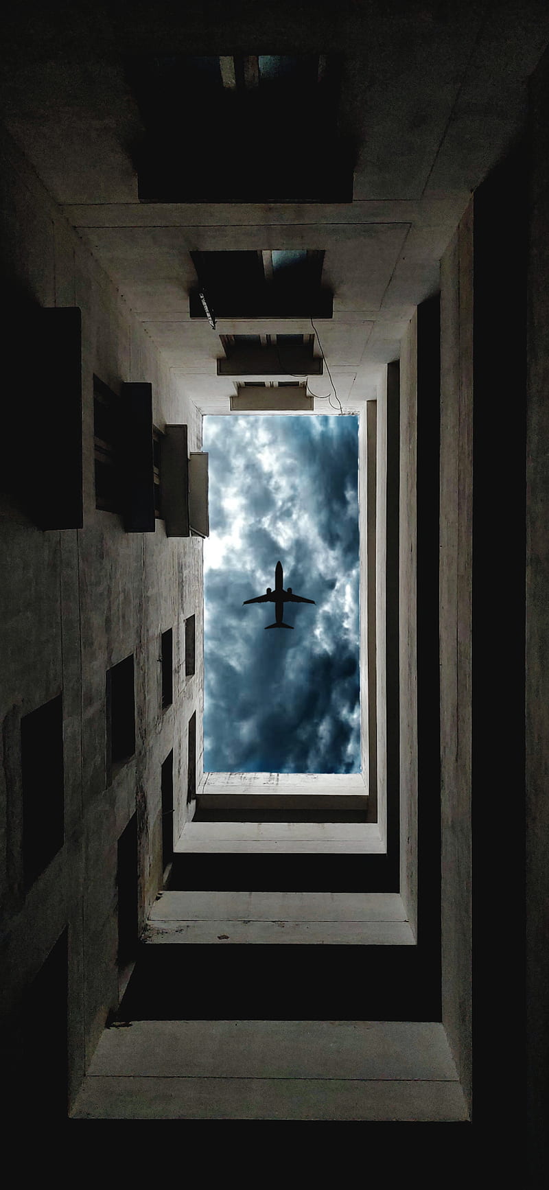 Cloudy day aeroplane, apartments, architecture, buildings, clouds, cloudy day, low angle, manipulation, rainy, HD phone wallpaper