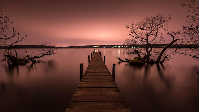 Pink Cityscape Silhouette, pink, silhouette, trees, lights, cityscape, pier, dusk, water, darkness, land, peach, night, HD wallpaper