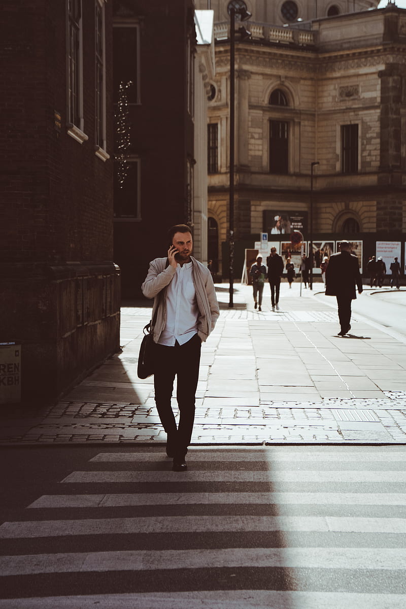 man holding phone while standing on pedestrian lane, HD phone wallpaper