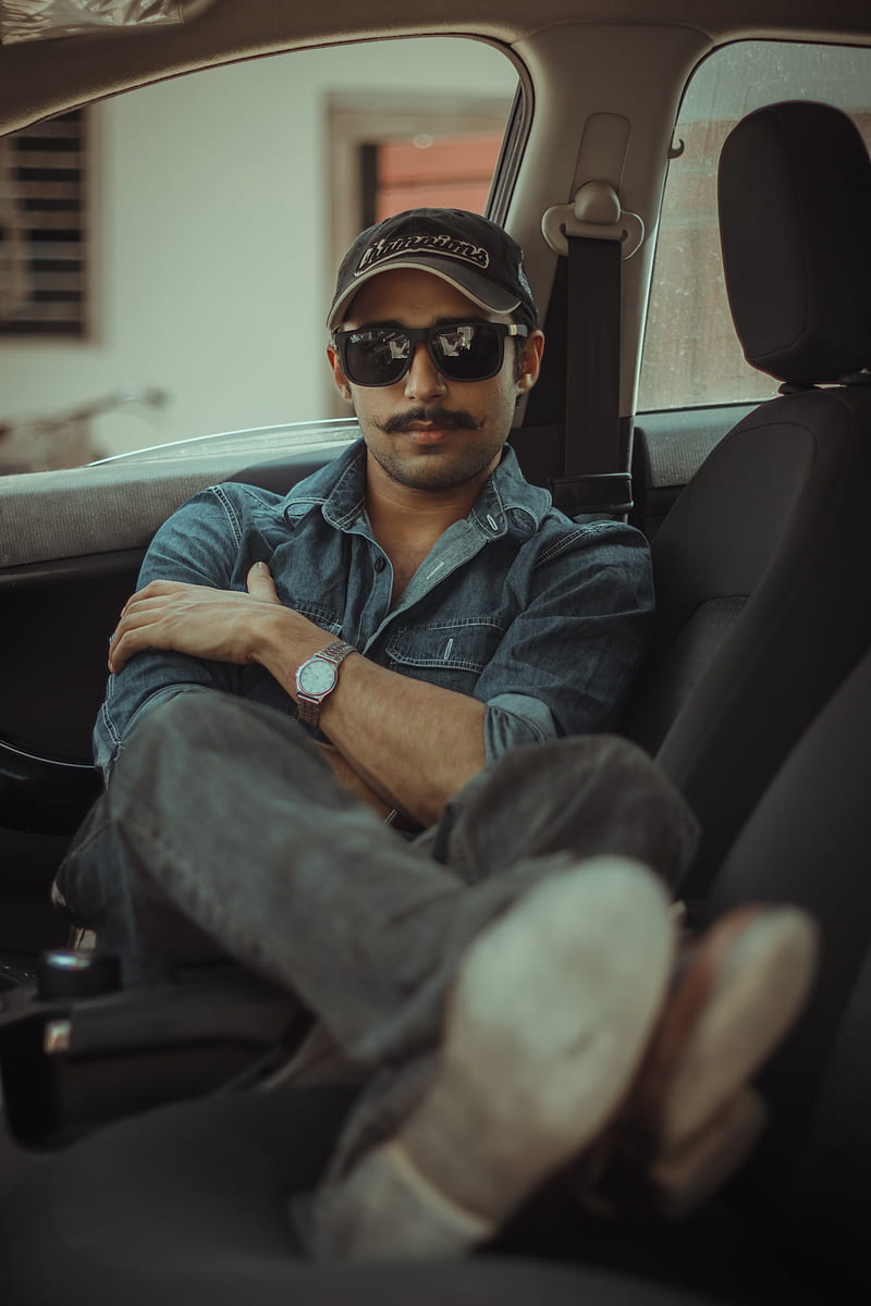 man in blue denim button up jacket wearing black sunglasses sitting on car seat, HD phone wallpaper