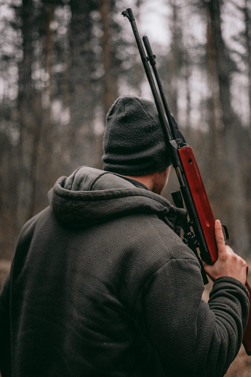 man holding brown and black sniper rifle in shallow focus graphy, HD phone wallpaper