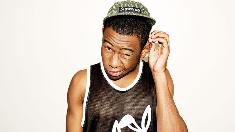 Tyler The Creator Is Wearing Supreme Green Cap And Black Sleeveless Tshirt With One Eye Closed In A White Background Music, HD wallpaper