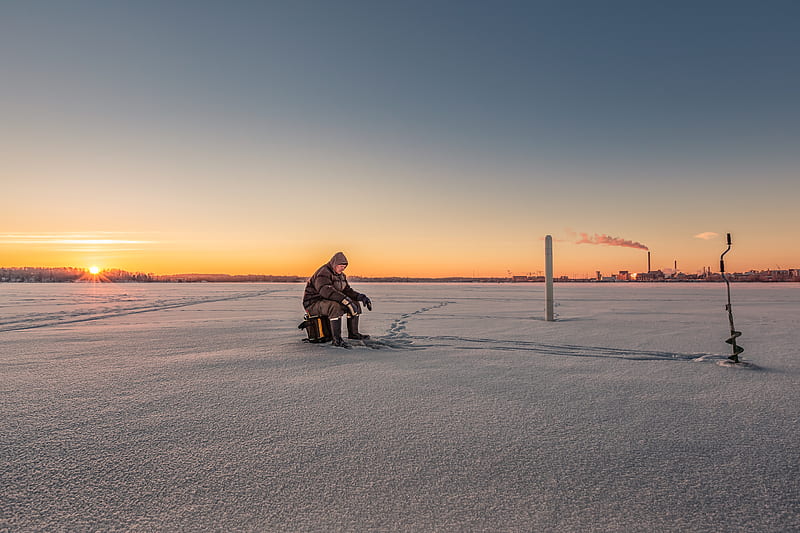 person sitting on stool on ice field near manual auger, HD wallpaper
