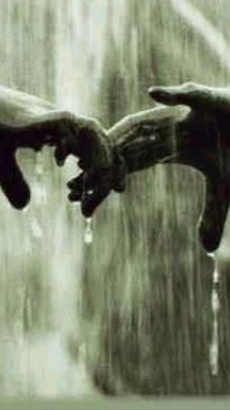 girl and boy holding hands in rain