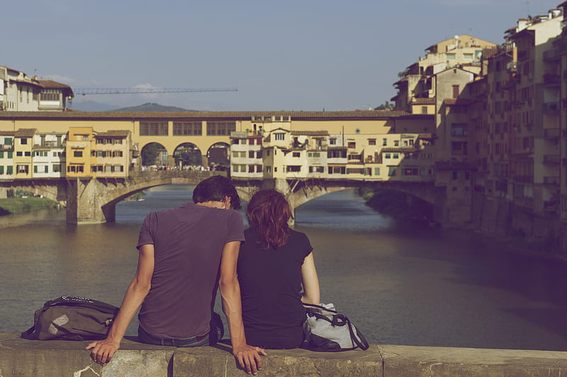 man and woman sitting together in front of body of water during daytime, HD wallpaper