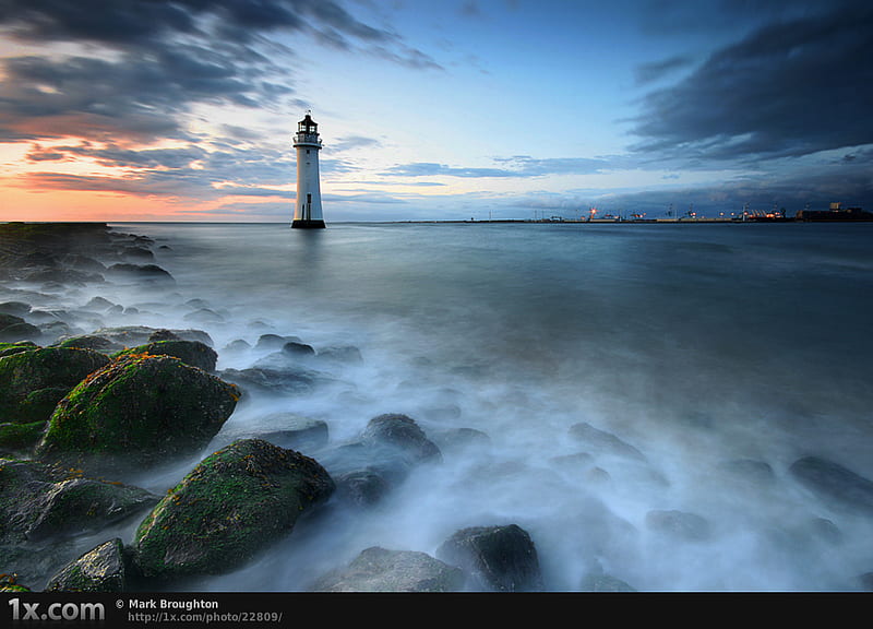 Distant lighthouse, rocks, cloud, ocean, sunset, sky, lighthouse, sea, harbour, nature, sunrise, blue, HD wallpaper