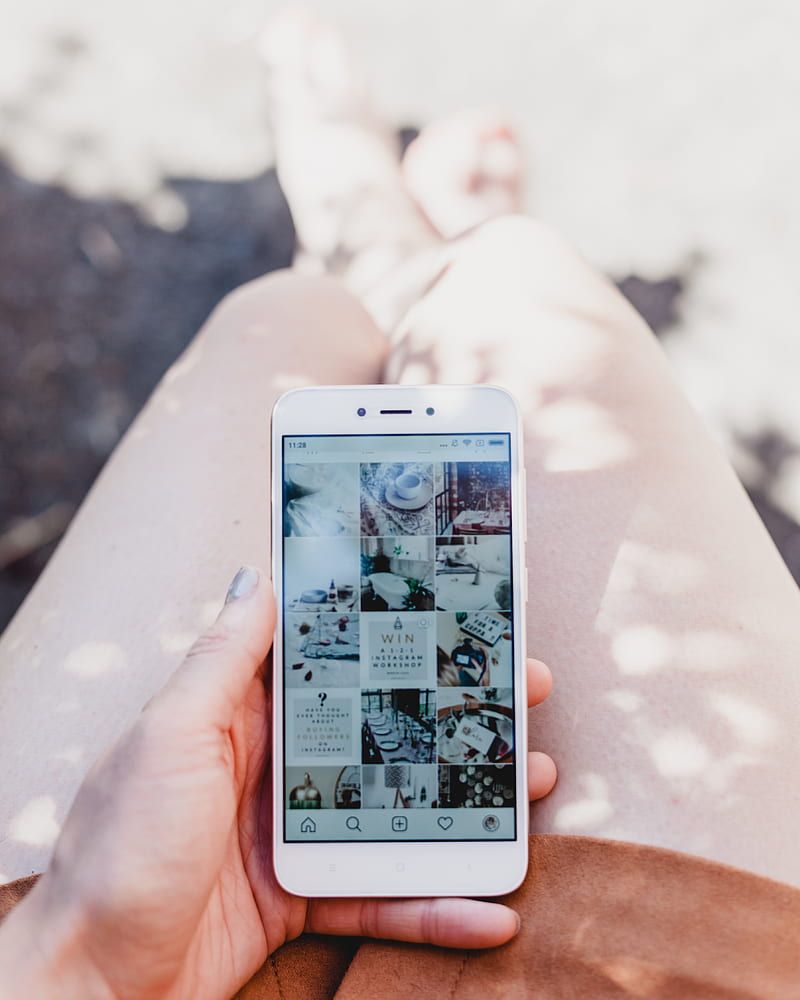 person holding white smartphone showing Instagram feed, HD phone wallpaper