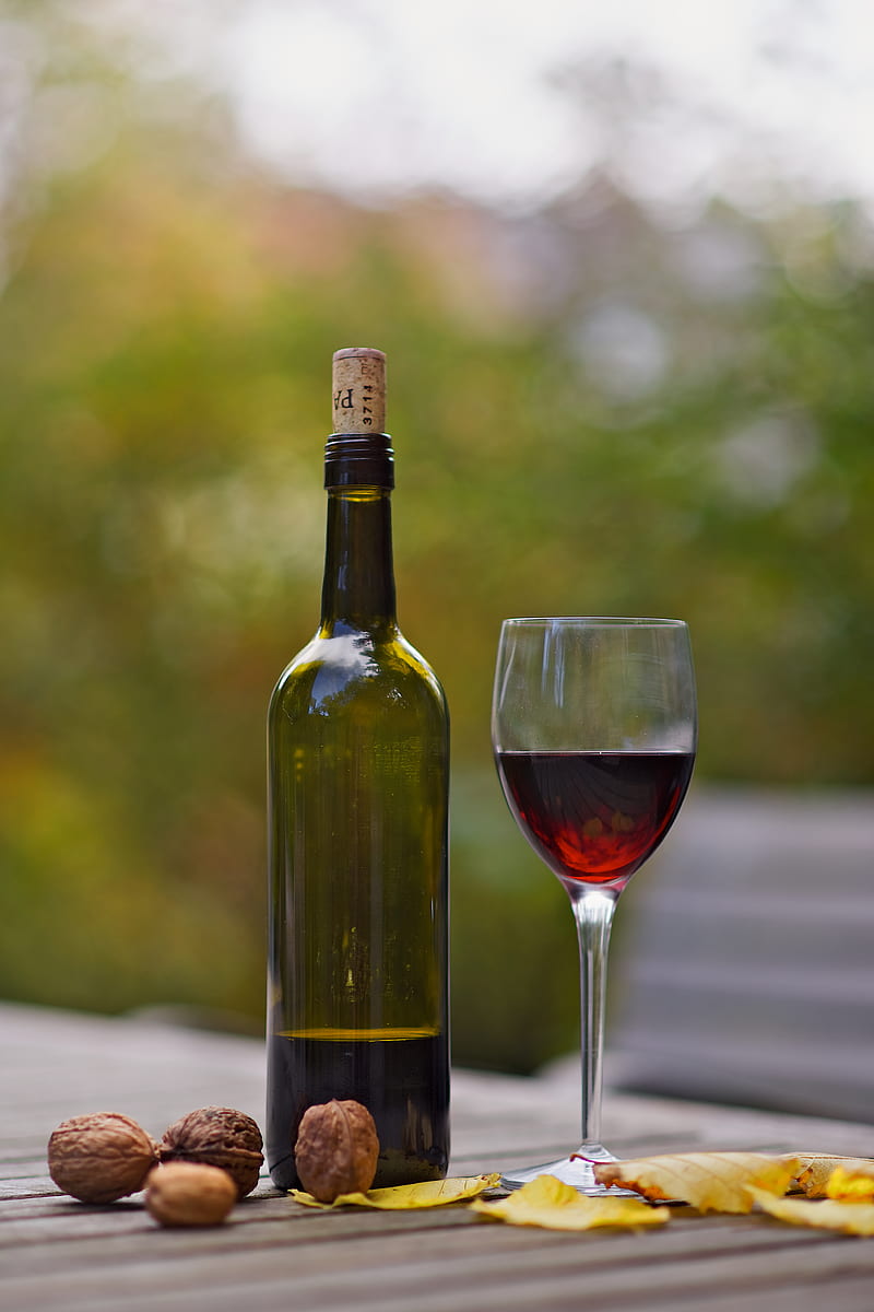 Wine bottle beside wine glass on brown wooden surface, HD phone wallpaper |  Peakpx