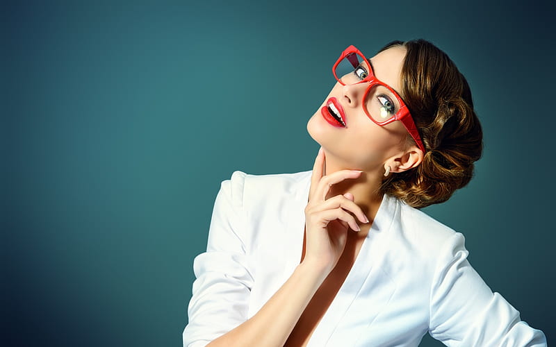 Do you have specs appeal. Studio shot of an attractive young woman striking  a pose against a grey background Stock Photo - Alamy