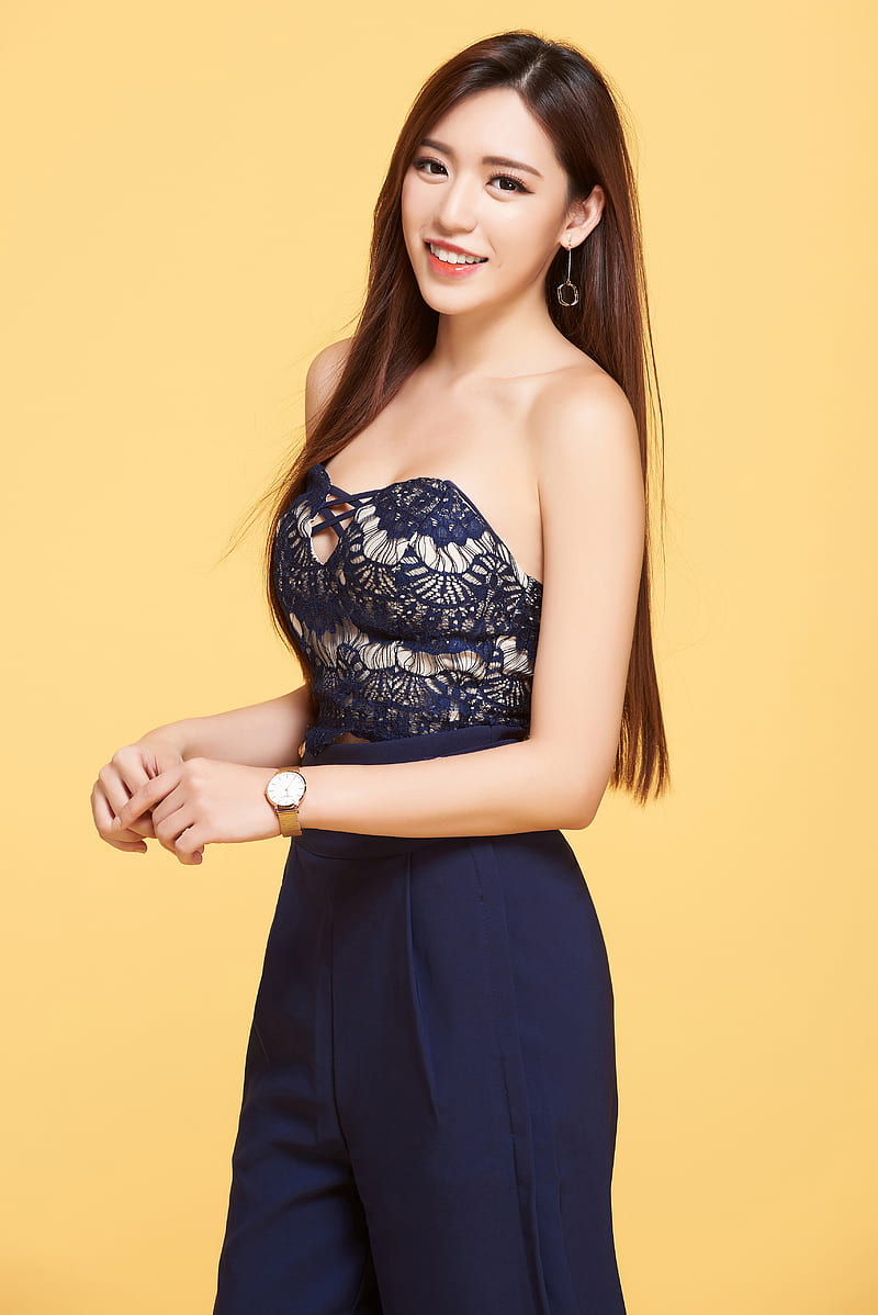 Kiki Hsieh, model, women, brunette, long hair, smiling, fashion, bare shoulders, yellow background, looking at viewer, watch, portrait display, Chinese model, Chinese, HD phone wallpaper
