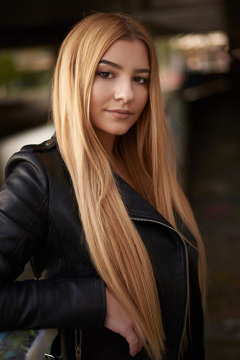 Image of Brown leather jacket with long blonde hair