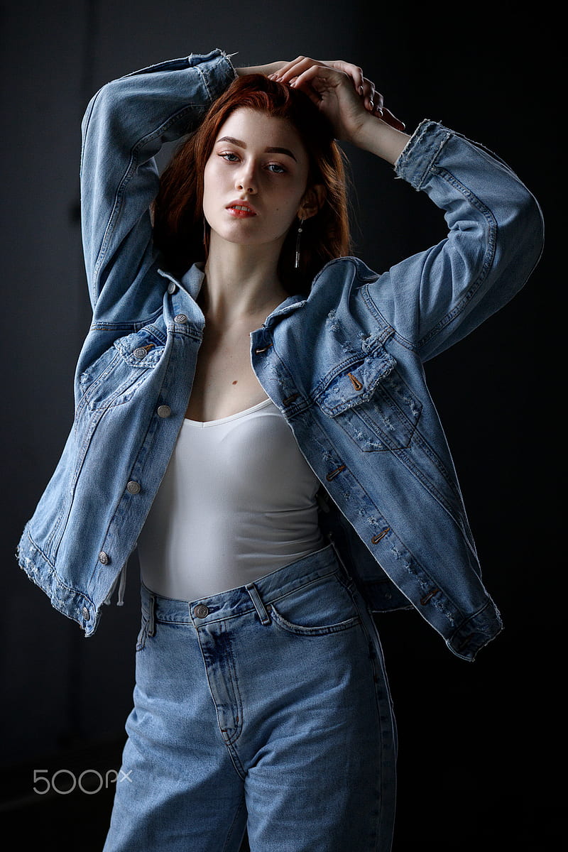 Beautiful young girl in denim jacket with a naked belly poses on camera  Stock Photo by ©ponomarencko 152643984