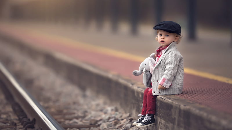 Cute Little Boy With Elephant Toy Is Sitting On Edge Of Railway Platform Wearing Red White Dress And Black Cap Cute, HD wallpaper