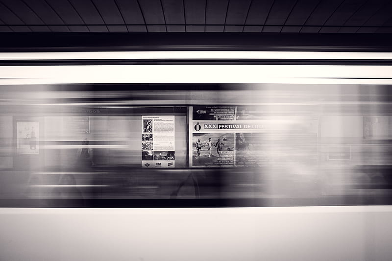A long-exposure shot of a moving subway train and advertisement posters at the station, HD wallpaper
