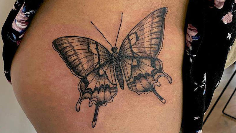 Classic Tribal butterfly thigh tattoos