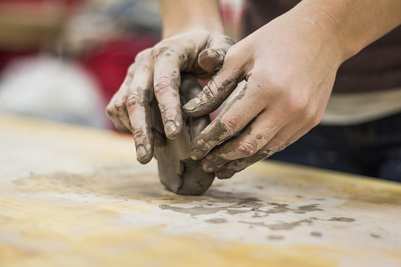 A clay stained hand of a potter engaging in a craft work of pottery or molding, HD wallpaper