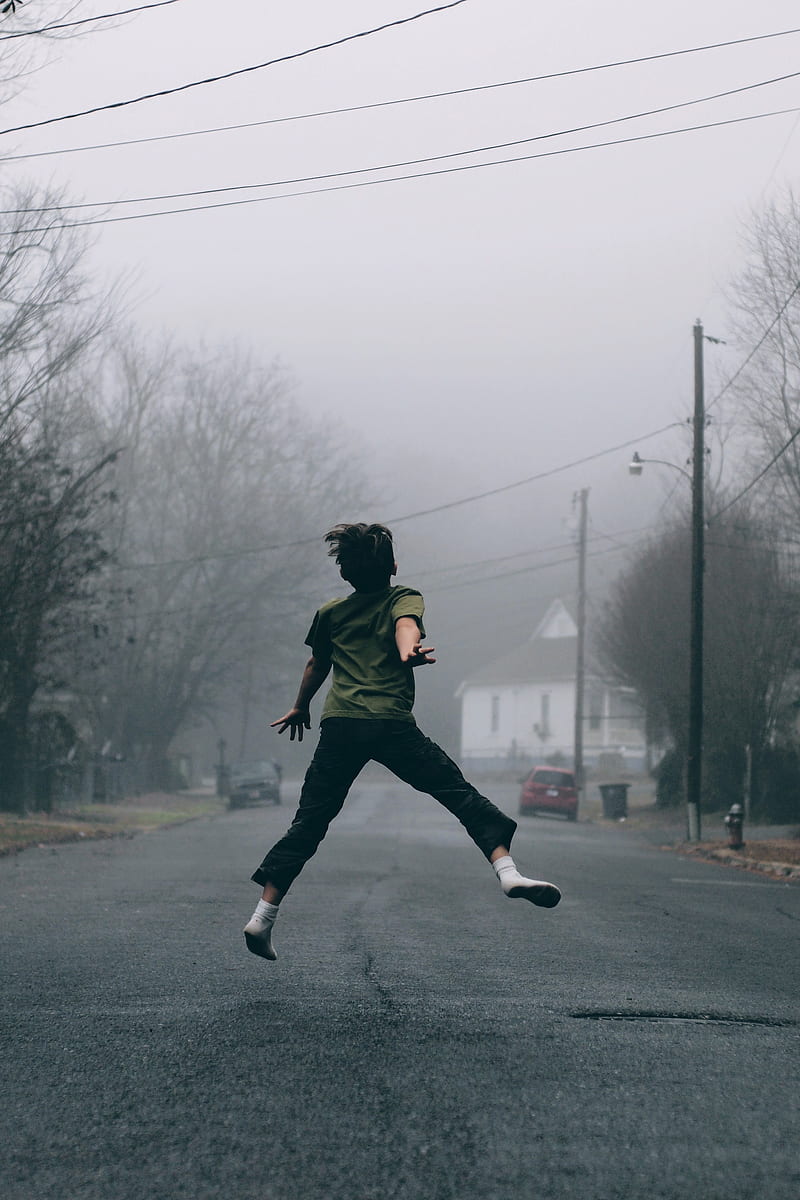 Kid jumps in the middle of the road on a foggy day, HD phone wallpaper