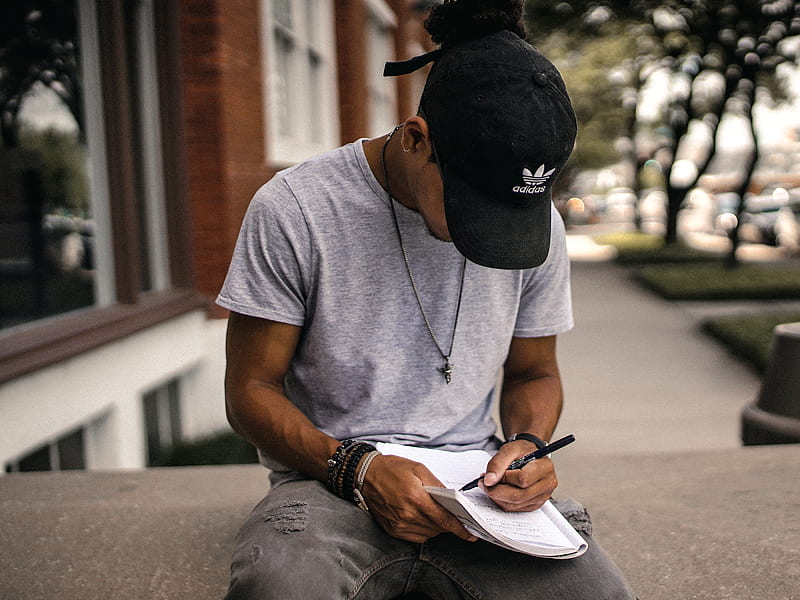 person in black adidas cap sitting on bench writing on notebook, HD wallpaper