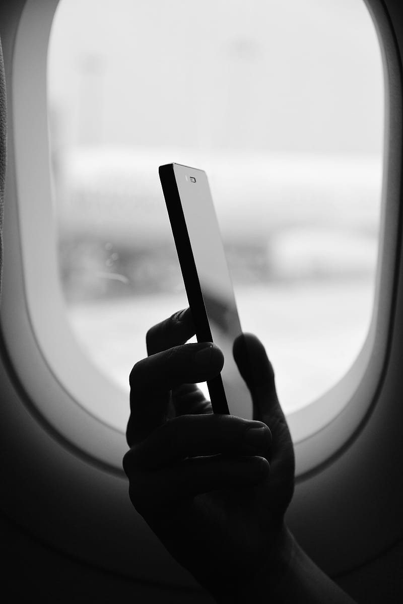 grayscale graphy of person holding smartphone beside window, HD phone wallpaper
